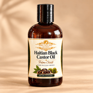 Simply Natu-Real Alchemy Haitian Black Castor Oil Palma Christi in an amber bottle on a warm beige background.