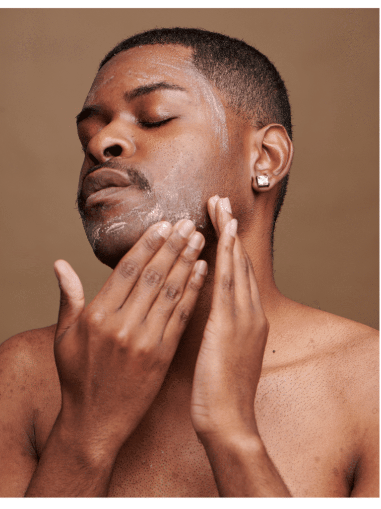 Man applying skincare cream to his face